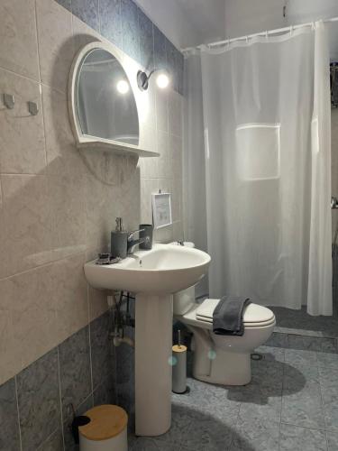 a bathroom with a sink and a toilet at Melivia apartments in Ierissos