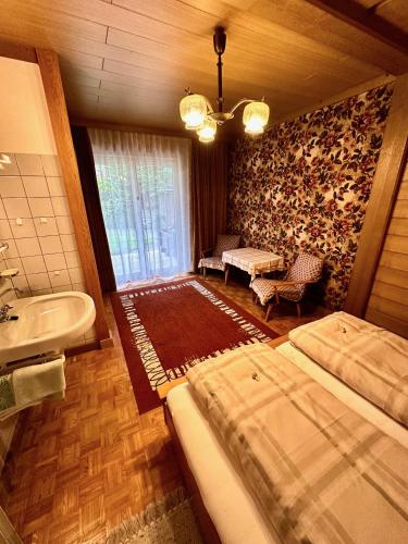 a bedroom with two beds and a tub and a sink at Ferienhaus Moßhammer in Lofer
