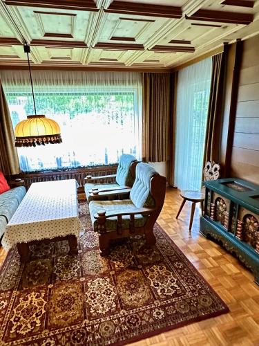a living room with a couch and a table at Ferienhaus Moßhammer in Lofer