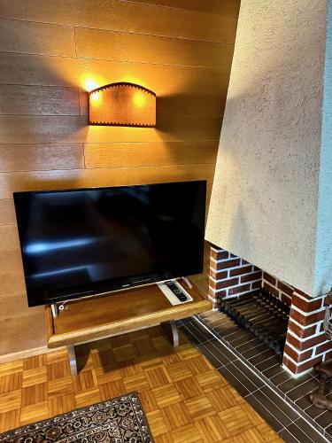 a large flat screen tv in a brick fireplace at Ferienhaus Moßhammer in Lofer