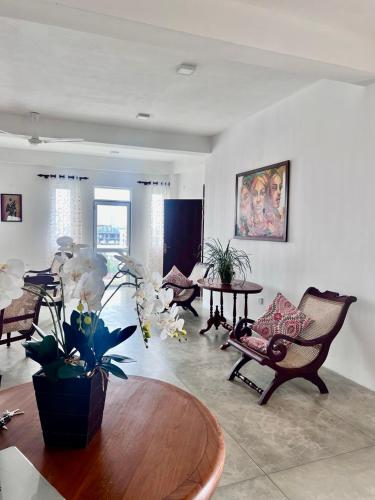 a large living room with a table and chairs at The Luxor Roof16 in Battaramulla