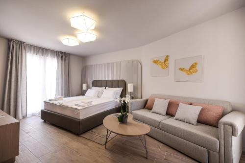 a bedroom with a bed and a couch at Arsenal Lofts in Zadar
