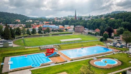 an aerial view of two swimming pools in a park at Apartament Nowar in Nowa Ruda