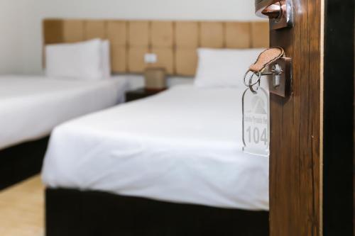a bedroom with a bed and a door with a price tag at Crowne Pyramids View inn in Cairo