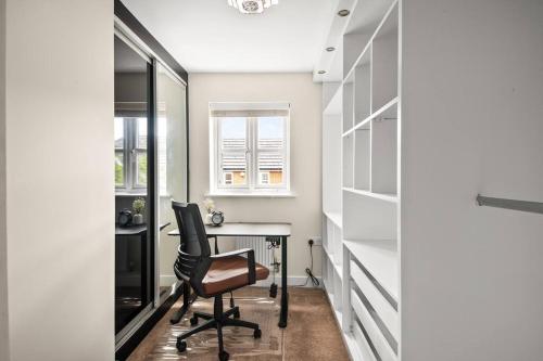a home office with a desk and a chair at Radiant Retreat Ideal for LegoLand, Windsor, & LHR in Slough
