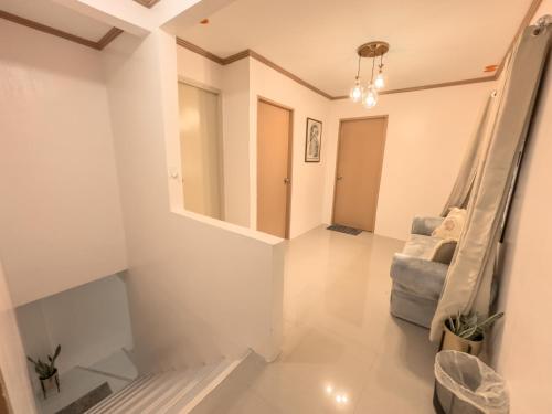 a living room with a couch and a mirror at La-Rivière Vacation Home in Lal-lo