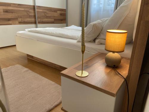 a bedroom with a bed and a table with a lamp at Holiday Home Mihaela in Višnjan