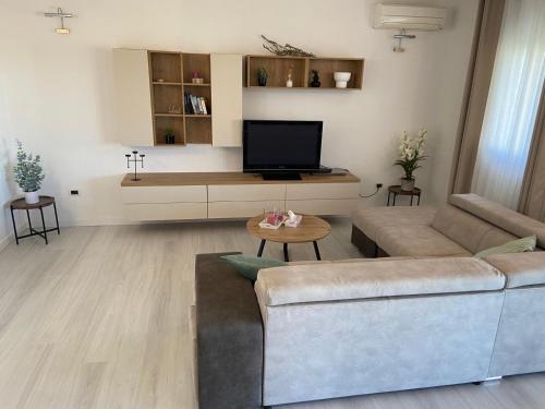 a living room with a couch and a tv at Holiday Home Mihaela in Višnjan