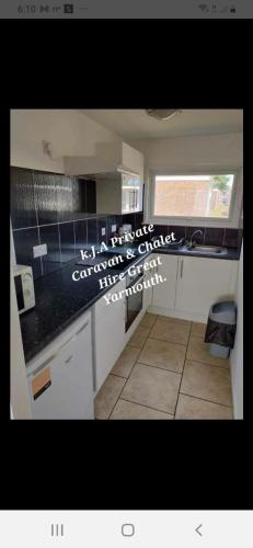 a kitchen with a counter top with writing on it at No.21 BERMUDA in Hemsby