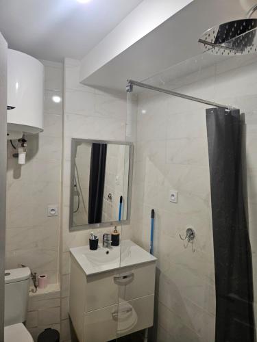 une salle de bain avec un lavabo, des toilettes et un miroir dans l'établissement Appartement moderne et sympa, à Béziers