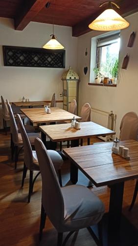 a dining room with wooden tables and chairs at Penzion Villa Marion in Mariánské Lázně