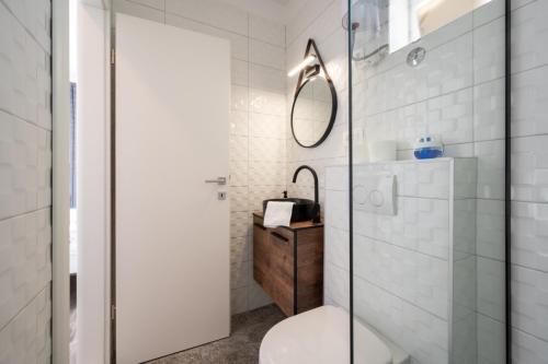 a bathroom with a toilet and a mirror at Ante room's in Trogir