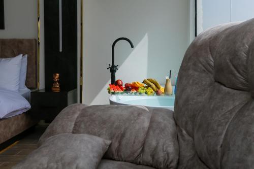 a couch in a living room with a bowl of fruit at Crowne Pyramids View inn in Cairo