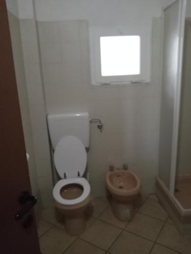 a bathroom with a toilet and a bidet at La Debbia Ranch in Vezzola