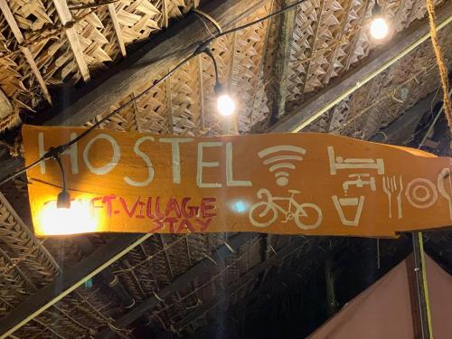 a sign hanging from the ceiling of a building at Delft Village Stay in Delft East