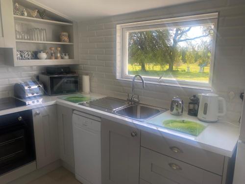 a kitchen with a sink and a window at Nolans organic farm in Wexford