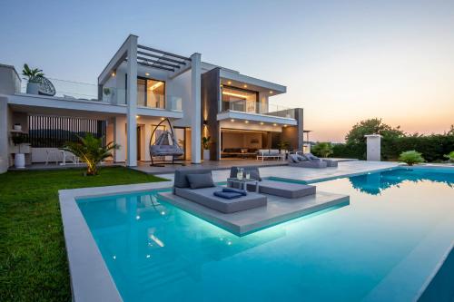 a house with a swimming pool in front of it at Horizon Dream Villas in Hanioti