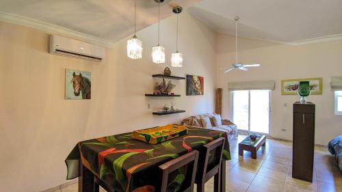 a living room with a table and a couch at Ocean Dream Art Deco Studio w/balcony in Cabarete