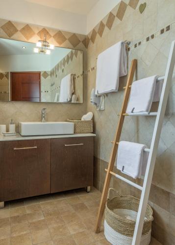 a bathroom with a sink and a mirror at Villa Marisol in Pollonia