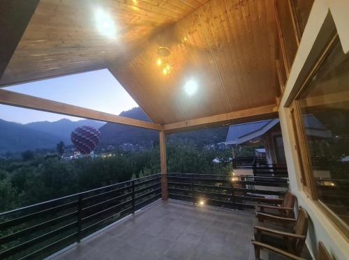 a balcony with a view of the mountains at Skyview Cottages Manali in Manāli