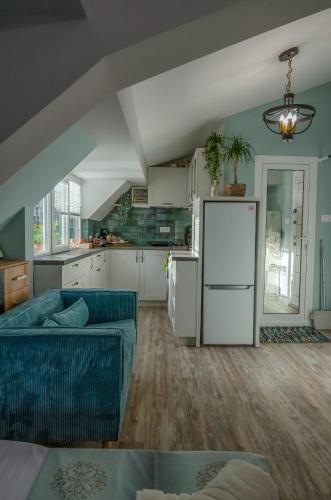 a kitchen and living room with a couch and a refrigerator at Bella in Nesebar