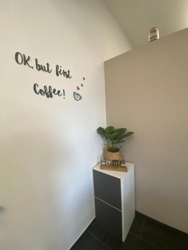 a room with a white wall with a plant on it at *Love'n fly apartament * Airport- Ducati in Bologna