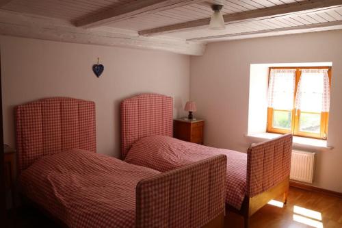 une chambre avec deux chaises et une fenêtre dans l'établissement Gite Fermette Francis à Lapoutroie, à Lapoutroie