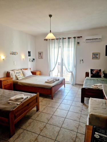 a living room with two beds and a table at Aegli Hotel Studios in Skala Potamias