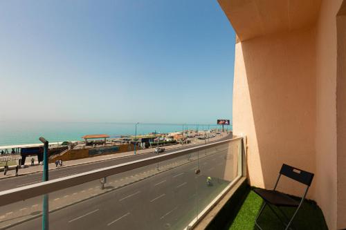 a balcony with a view of the beach at Alex Inn in Alexandria