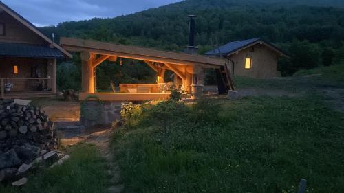 a wooden house with a porch in a field at To Lem Ande in Lumshory