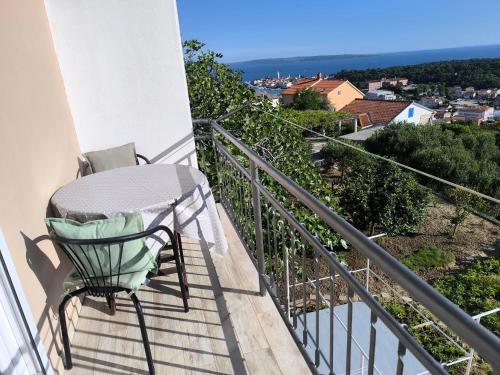 a chair sitting on a balcony with a view at Panoramic view studio in Rab