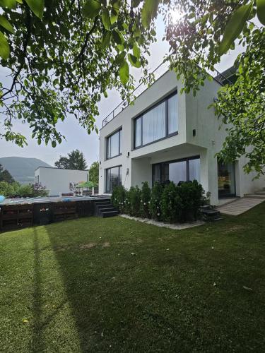 a white house with a lawn in front of it at La bella vue in Osenjače