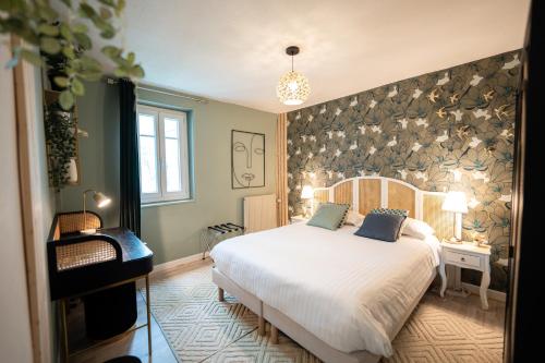 une chambre avec un lit blanc et un mur dans l'établissement Villa Vichéia - Appartement 31, à Vichy