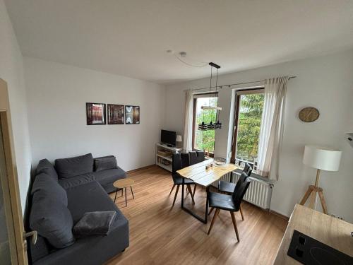 a living room with a couch and a table at Ferienwohnung Daisy in Sankt Andreasberg