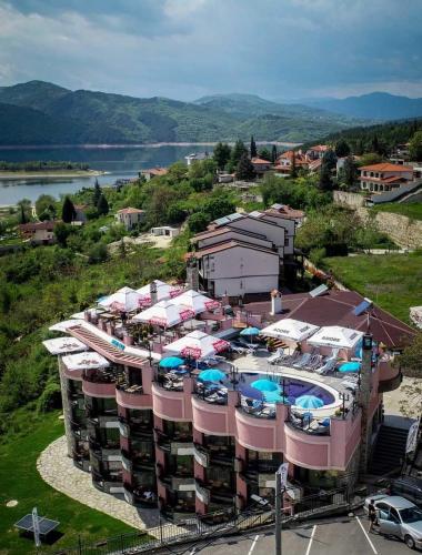 an aerial view of a resort with a pool and umbrellas at MOBI DICK Family Hotel in Glavatartsi