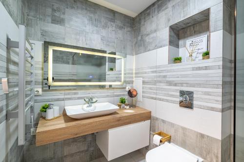 a bathroom with a sink and a toilet at Boutique 1 bedroom apartment with Private Parking and Port View in Varna City