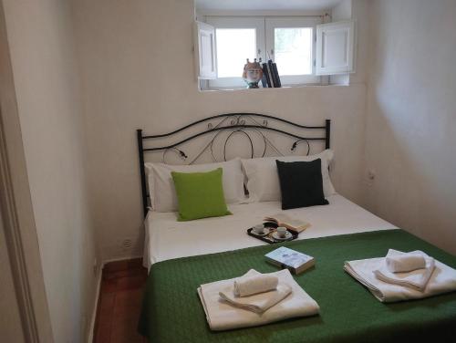 a bedroom with a bed with two towels on it at Erice Appartamenti in Erice