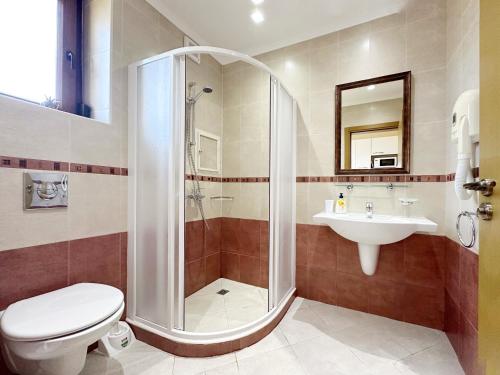 a bathroom with a shower and a toilet and a sink at Studio Sun Marina in Sozopol