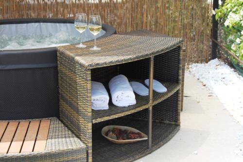 a table with two wine glasses on top of it at La linea dell'orizzonte in Alberobello