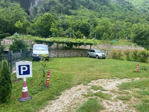 a parking lot with two cars parked in a yard at Vila Alexander B&B in Valbonë