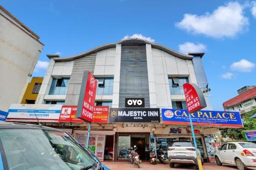 a building with cars parked in front of it at OYO Majestic Inn in Trivandrum