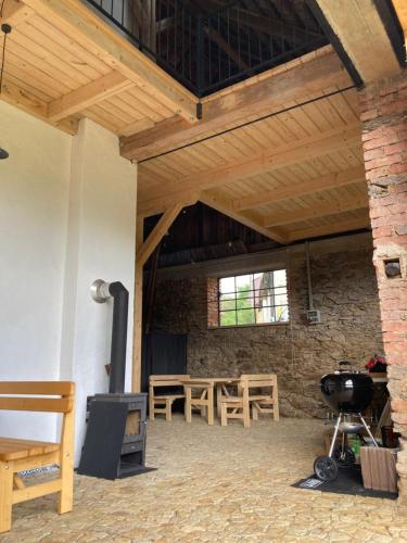 a room with a grill and a brick wall at Stodola 63 in Pacov