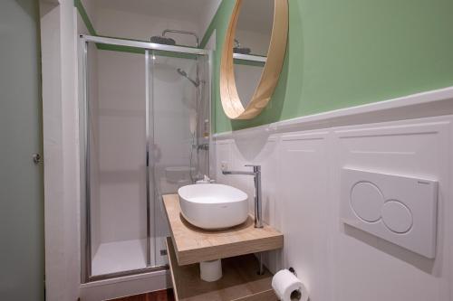 a bathroom with a sink and a glass shower at Room & Breakfast D'Annunzio in Ravenna