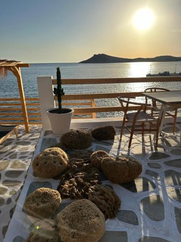 a table with donuts on it with the ocean in the background at SPONGIA HOTEL SUITES & Spa in Myrties