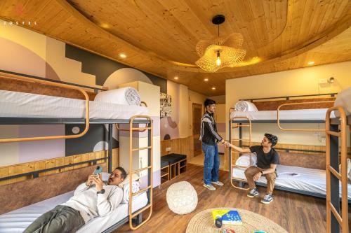 a group of people in a dorm room with bunk beds at Zostel Old Manali, Goshal Road in Manāli