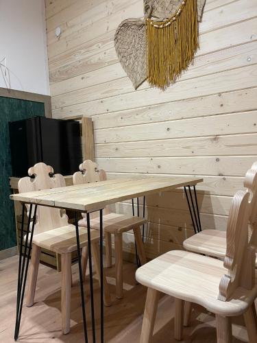 a dining room with a table and chairs at Wioska w Sowich Sokolec in Sokolec