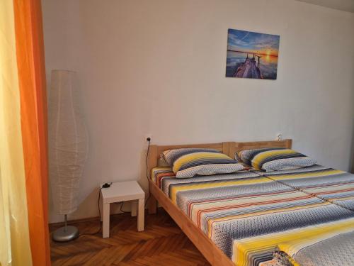 a bedroom with two beds and a picture on the wall at City Center Stay in Visoko