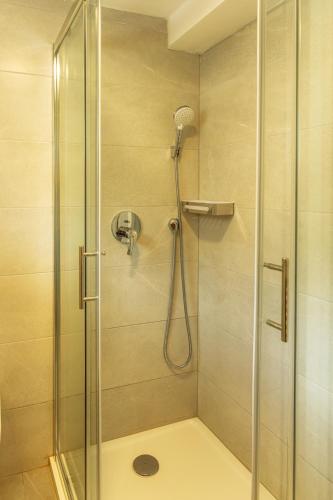 a bathroom with a shower with a glass door at House Villa Katarina in Malinska