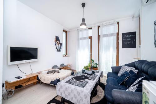 a living room with a couch and a tv at Bulrock Residance in Sofia