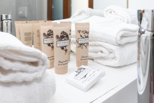 a pile of towels on a counter with towels at La Villa Del Senatore in Gravina in Puglia